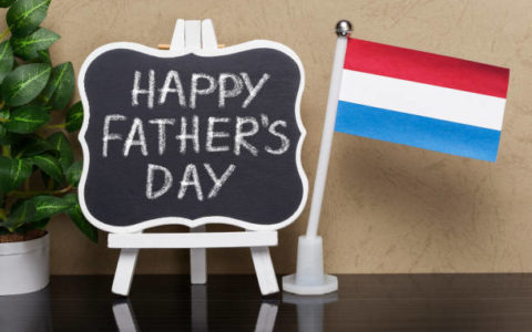 Blackboard with text ,,Happy Father's Day " and flag of Luxembourg